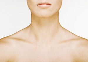 Woman's lower face, neck and bare upper chest